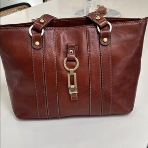 vintage Etienne Aigner brown leather tote bag with gold-tone hardware.